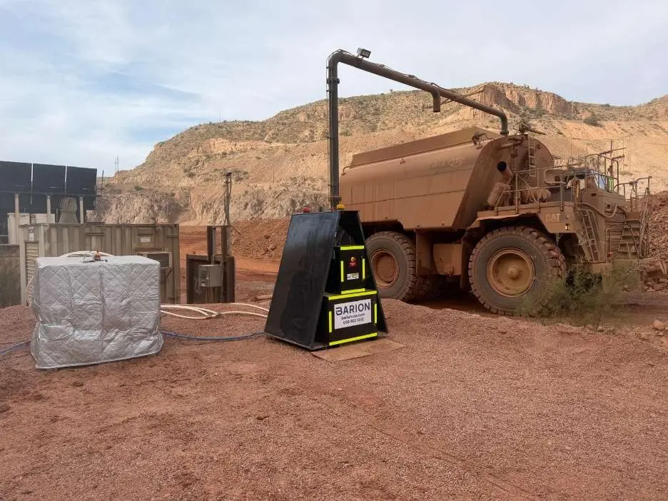 Automated Barion dosing station beside a mine water truck